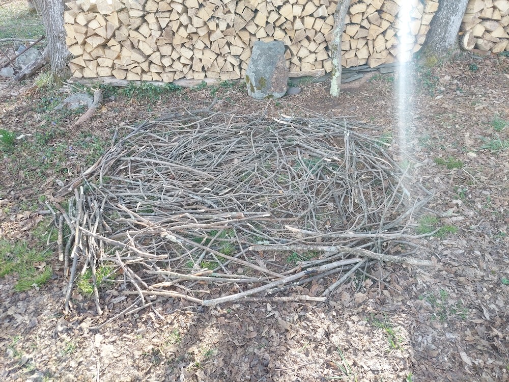 The base of the holz hausen, made of tree limbs and branches, and built to a 6-foot diameter.