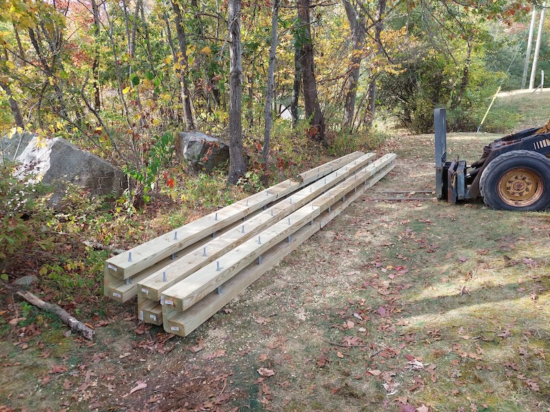Three open-top box culverts: long three-sided wooden boxes with steel bars inside to stabilize the sides.