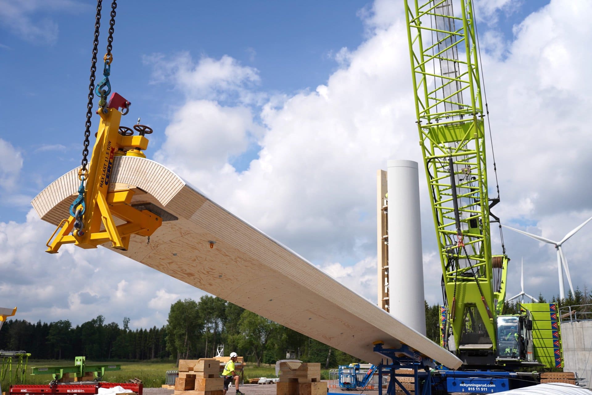 Picture of a section of wooden tower being lifted up to install.