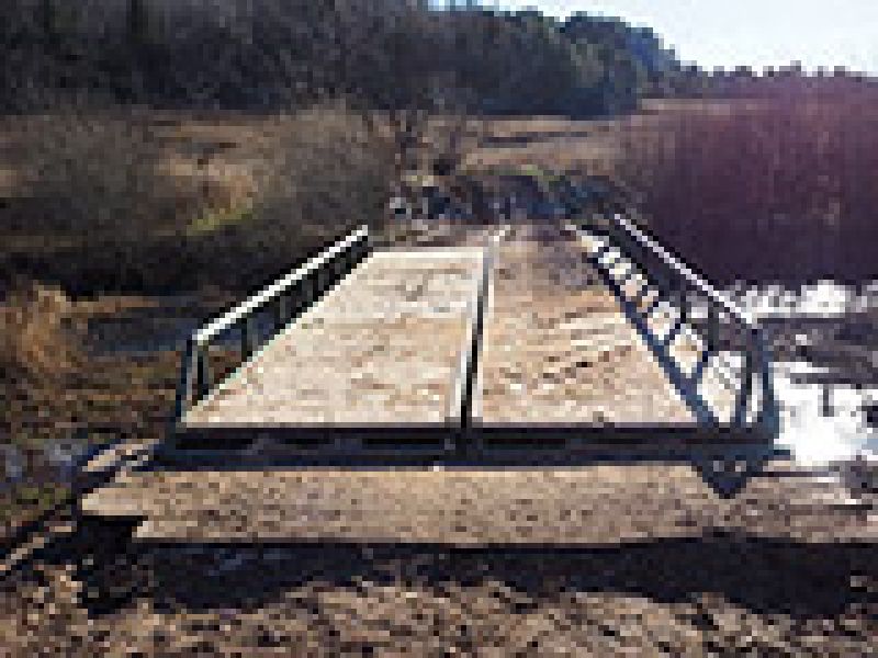 Replacing the decking on a 30-foot portable bridge