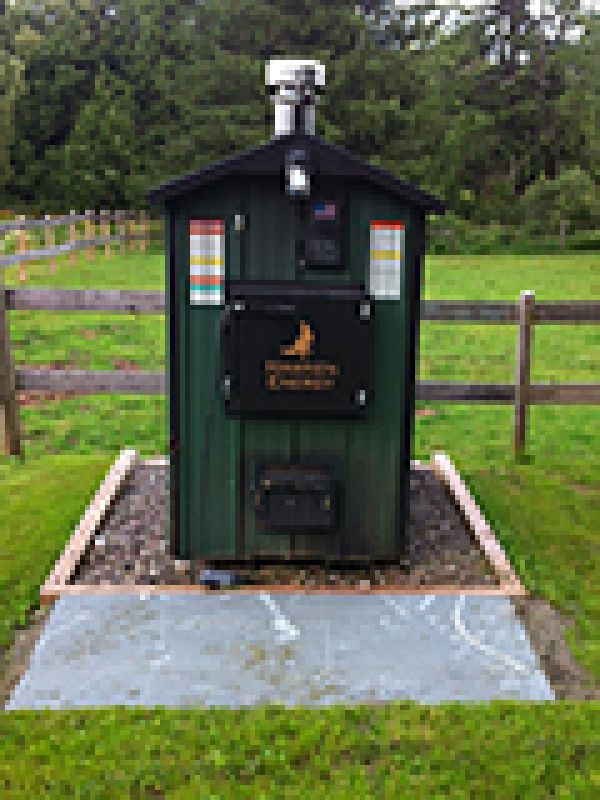 The Hawken wood furnace installed with added bluestone slab in front.